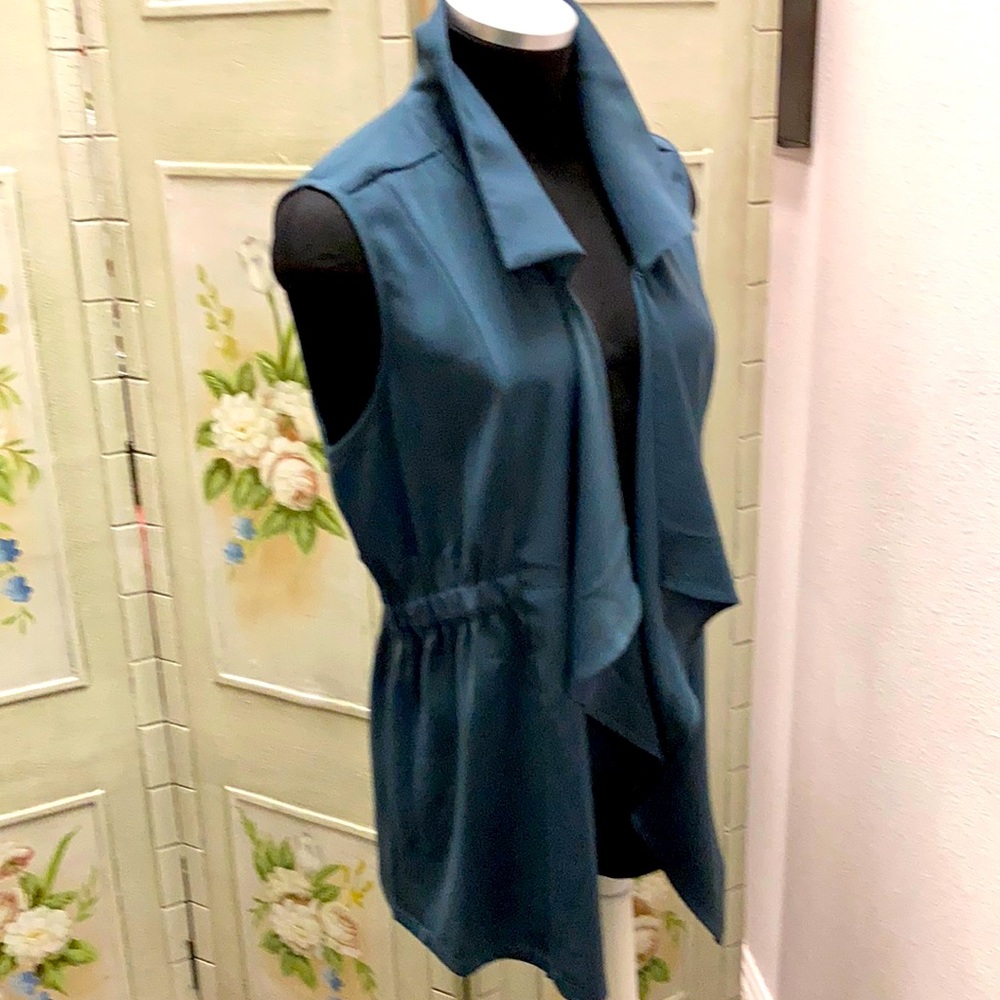 This is a classy high collar cinched waist vest